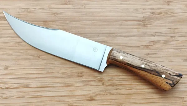 Left side of Florida Pecan Upswept Clip Point, 12 5/8" Nada-Bowie with pecan handle, brass pins and a brushed blade