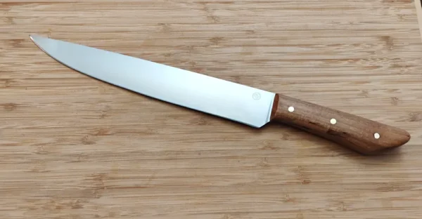 Left view of 9 1/4" Florida Pecan Carving Knife, 14" long, with a brushed drop point blade and pecan handle on wood.