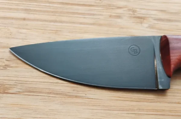 Left side of coffee etched blade showing company logo on custom camping knife with mild steel pins.