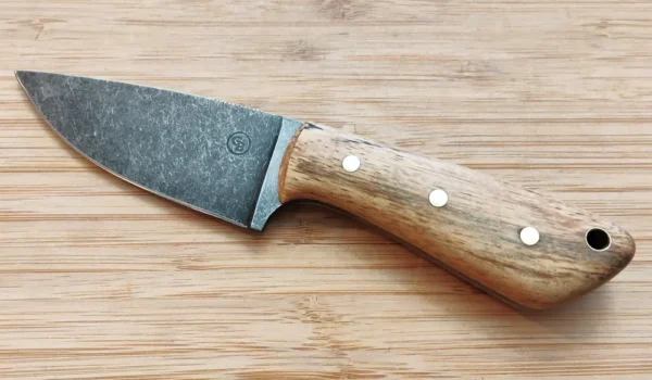 Left side view of the Drop Point Pecan 3-Finger Skinner knife, featuring a 3 1/2-inch stonewashed 1095 high carbon steel blade