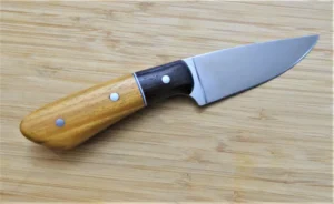Right side of GreBec Goldilocks #207 knife with brushed drop point blade, Osage Orange handle, and Wenge bolster.