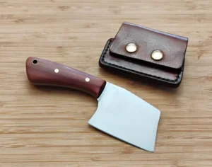 6 7/8" Mini Cleaver EDC with brass pins and lanyard tube next to leather sheath