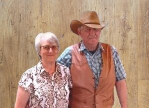 Founders of GreBec Knives standing infront of a wood wall background