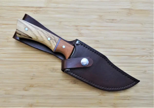 Pecan Nada Bowie knife in custom hand-dyed leather sheath, showcasing Florida-crafted hunting gear.