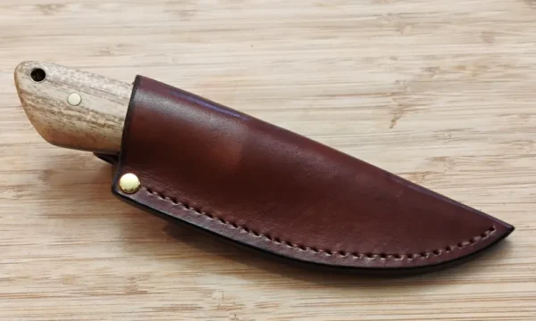 GreBec Knives Drop Point 3-Finger Skinner knife sheathed in its custom handcrafted leather pouch, highlighting portability