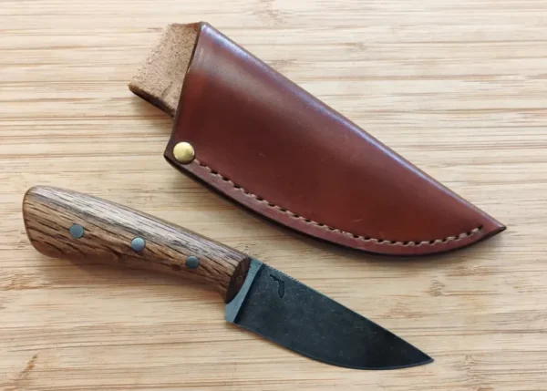 Bur Oak Caping Knife #334 next to custom leather belt loop sheath