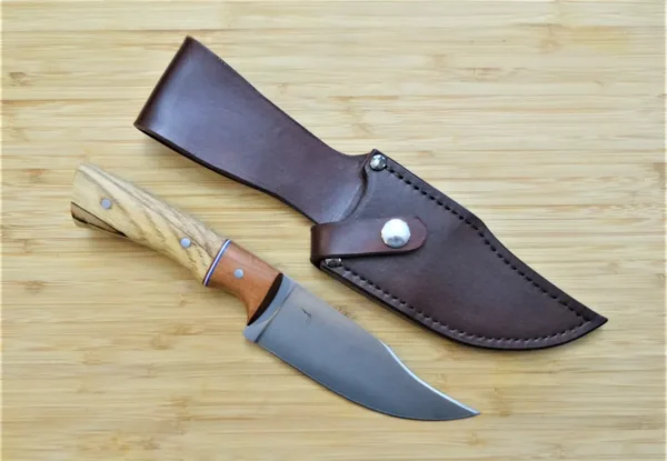 Pecan Nada Bowie upswept clip point knife with custom hand-dyed leather sheath, showcasing Florida-crafted hunting gear.