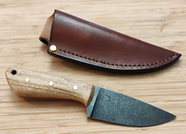 GreBec Knives Drop Point 3-Finger Skinner knife next to its handcrafted leather pouch sheath