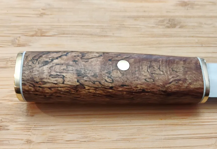 Right side of custom Puukko knife handle crafted from stabilized Florida Southern Red Oak with brass pin
