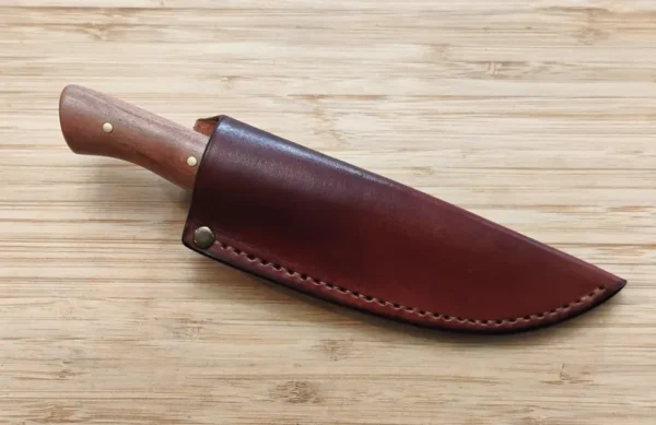 Wild Black Cherry Harpoon Clip Point #343 knife securely placed in custom leather pouch sheath