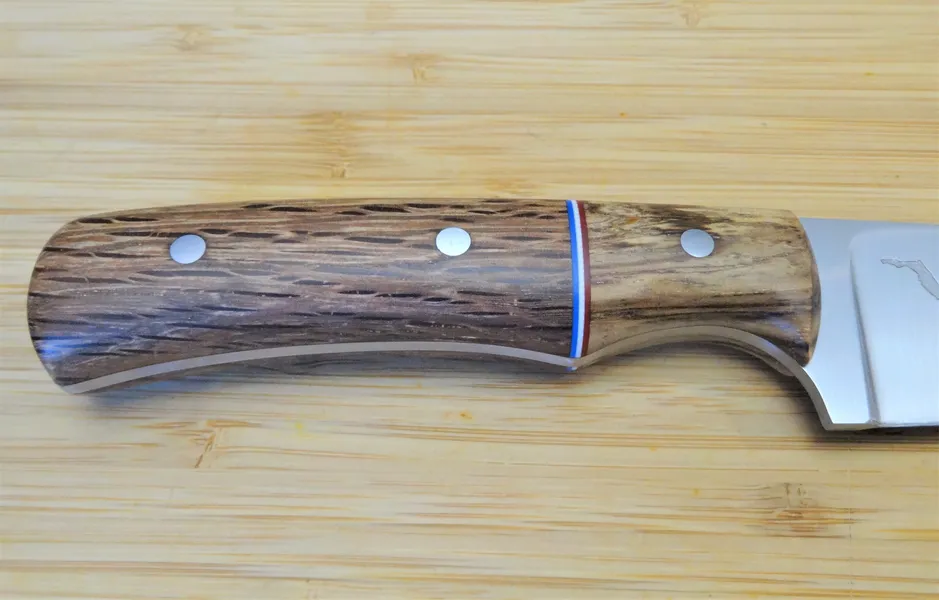 Florida Wood Series - Southern Red Oak custom knife handle with spalted pecan bolster and red, white and blue spacers on a wooden background