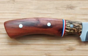 Right view of knife handle made with Wild Plum and a bolster of Spalted Bur Oak with red, white and blue G10 spacers