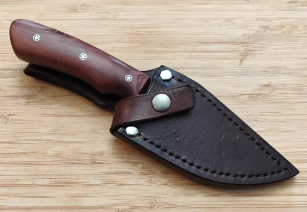 Red Cedar Chubby #353 custom knife securely stored in its custom veg-tanned leather sheath, dyed to match.